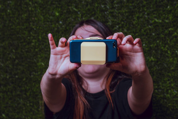 Girl with a black t-shirt showing yellow virtual reality glasses on the outside