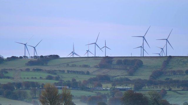 British/Scottish rural landscape (South lanarkshire) at dusk with wind turbines at the  distance