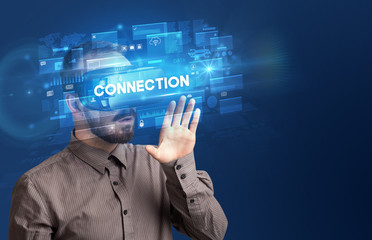 Businessman looking through Virtual Reality glasses with CONNECTION inscription, innovative security concept