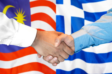 Business handshake on the background of two flags. Men handshake on the background of the Malaysia and Greece flag. Support concept