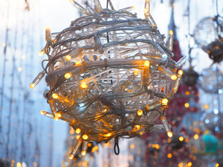 Street Christmas decorations in the form of a garland twisted into a ball. Close up