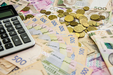 Ukrainian hryvnia, calculator and coins. Money background. Business concept.