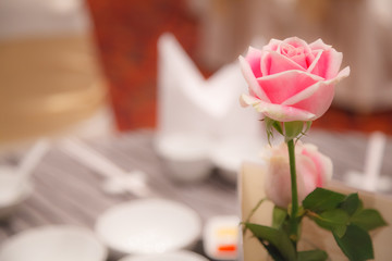Pink rose decoration on banquet table settings. Hotel restaurant venue, food catering service buffet or cocktail banquet for wedding ceremonies, seminars, meetings, conferences, parties or events.