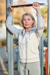 Fototapeta premium Elderly attractive woman during sports by the sea.