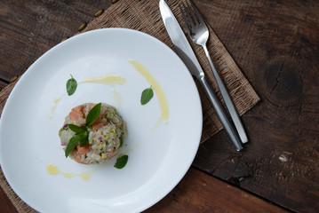 Tartar salmon with herbs on white dish