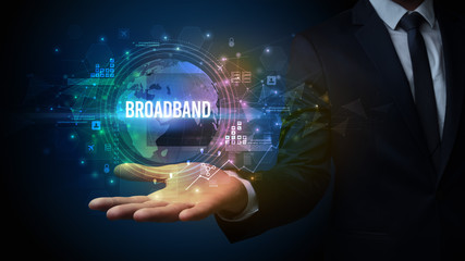 Elegant hand holding BROADBAND inscription, digital technology concept