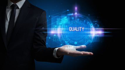Obraz premium Man hand holding QUALITY inscription, technology concept