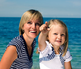 Fototapeta na wymiar mother with daughter at sea cost together, happy real family smiling looking to horizont, lifestyle people concept, on vacations close up