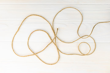wooden background. white color. there is a rope on it. close-up.
