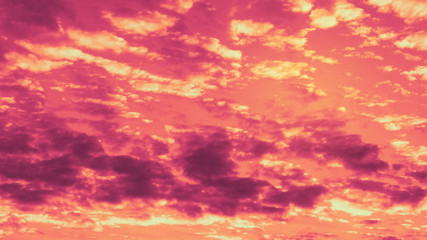 Evening sky with clouds during sunset in warm colors_