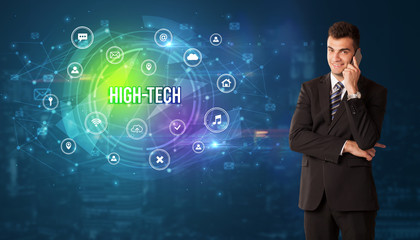 Businessman thinking in front of technology related icons and HIGH-TECH inscription, modern technology concept