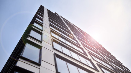 Modern office building detail, glass surface with sunlight