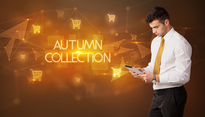 Businessman with shopping cart icons and AUTUMN COLLECTION inscription, online shopping concept