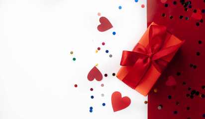 Happy postcard  Valentine's day gift and hearts on white and red background, top view with place for congratulations