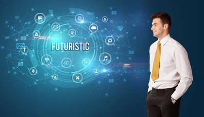 Businessman thinking in front of technology related icons and FUTURISTIC inscription, modern technology concept