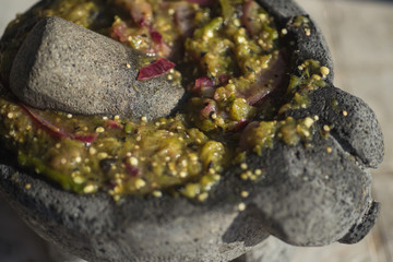 A molcajete and tejolote are stone tools, traditional Mexican version of the mortar and pestle, similar to the South American batan, used for grinding various food, spice, salsas and guacamole
