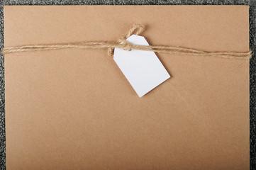 Brown envelop with white paper tag