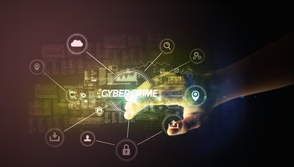 Hand touching CYBERCRIME inscription, Cybersecurity concept