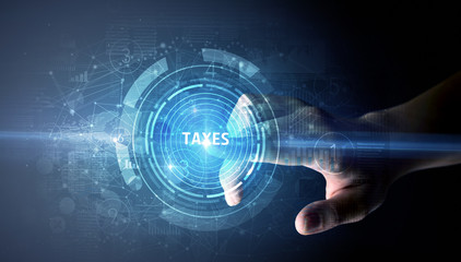 Hand touching TAXES button, modern business technology concept
