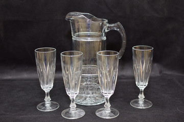 Mock up  design set of elegant and traditional drink ware / drinking glass & Jar for wine or juice, transparent isolated on black background template for branding identity and company logo