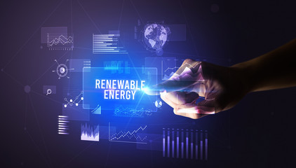 Hand touching RENEWABLE ENERGY inscription, new business technology concept