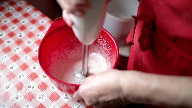 Housewife mixes the egg foam with a food processor for pasrty, slow motion footage
