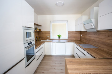Fototapeta na wymiar White new modern kitchen in house