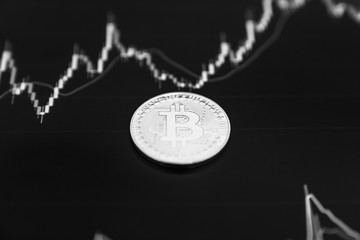 Fototapeta na wymiar Bitcoin on the black graph. New online currency.