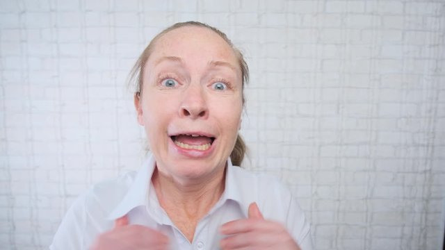 Portrait of adult crying woman making excuses in office on light background.