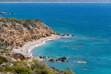 Scenic view at beach Akra Fourni nearby Monolithos  at Rhodes island with green vegetation in the foreground and the aegean sea in the background - obrazy, fototapety, plakaty