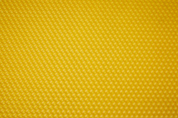 Texture of honeycomb. Bright yellow background. Honey cells. Top view. Honey cell pattern, mosaic...