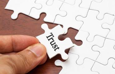 Placing missing a piece of puzzle with trust word