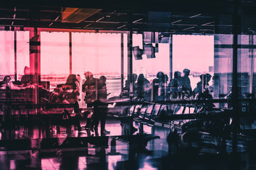 Obraz premium silhouettes of people on airport boarding 