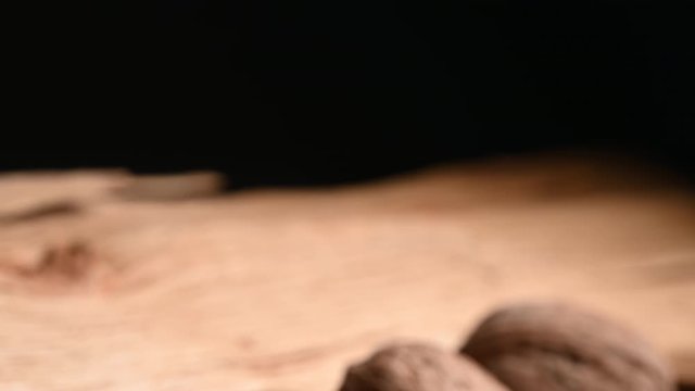 two walnuts on top of their  wood