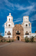 Fototapeta na wymiar Frontal shot of Mission of San Xavier del Bac in Tucson with church tower and historic entrance
