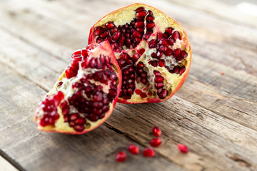 broken pomegranate on a wooden grungy background