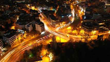Fototapeta na wymiar Aerial drone night shot of illuminated cityscape of Athens, Attica, Greece