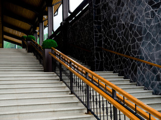 Concrete staircase with wooden railing. Bottom view