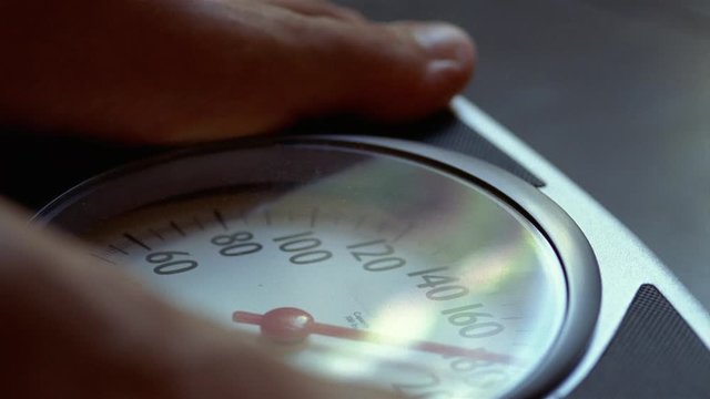 Close-up of a young man's feet on a weight scale