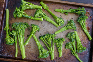 Raw Broccolini Tossed with Olive Oil on a Sheet Pan