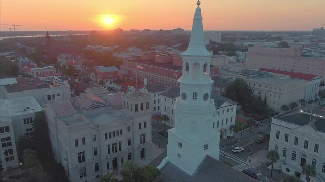 Aerial: Charleston Saint Michael's Church on Broad St and city skyline at sunset. South Carolina, USA. 8 August 2019