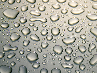 Pattern of water drops on a metal background. Abstract background. Gray metal surface. The texture of the water