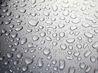 Pattern of water drops on a metal background. Abstract background. Gray metal surface. The texture of the water