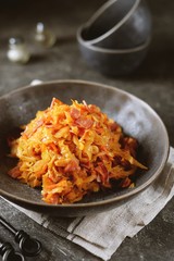 Braised cabbage with ham, onions and carrots. Traditional Russian food.