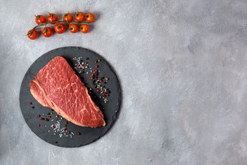 Raw fresh marbled meat and seasonings on grey background top view