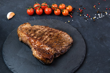 Grilled beef steak ribeye rare on on dark background