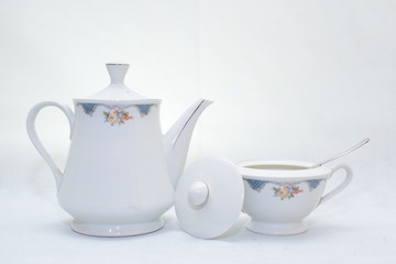 Mock up / design set of elegant and traditional teapot colorful white and blue coffee cup & Tea cup on cup's plate beside the hot tea pot , design/ drink-ware isolated on white background