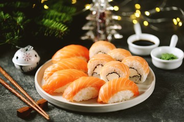 Philadelphia homemade sushi rolls and nigiri sushi with wild salmon,  christmas background. 