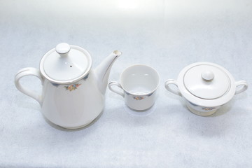 Mock up / design set of elegant and traditional teapot colorful white and blue coffee cup & Tea cup on cup's plate beside the hot tea pot , design/ drink-ware isolated on white background