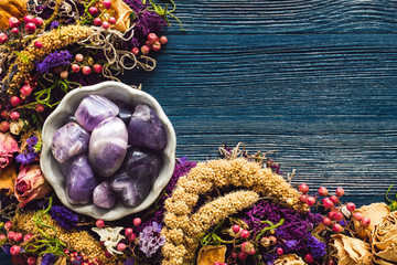 Amethyst with Dried Flowers and Moss on Blue Background